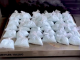 Dozens of small clear plastic bags filled with light blue pills are arranged in rows on a tabletop scale labeled “Mettler Toledo,” with a computer keyboard partially visible to the side.