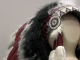 This image features a Native American-style headdress displayed on a neutral-toned mannequin head. The piece is highly detailed, showcasing traditional craftsmanship through various textures and materials.