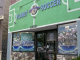 The storefront of Planet Soccer features a bright green facade with a soccer field design, large signage above the entrance, and window displays filled with soccer gear and promotional posters.